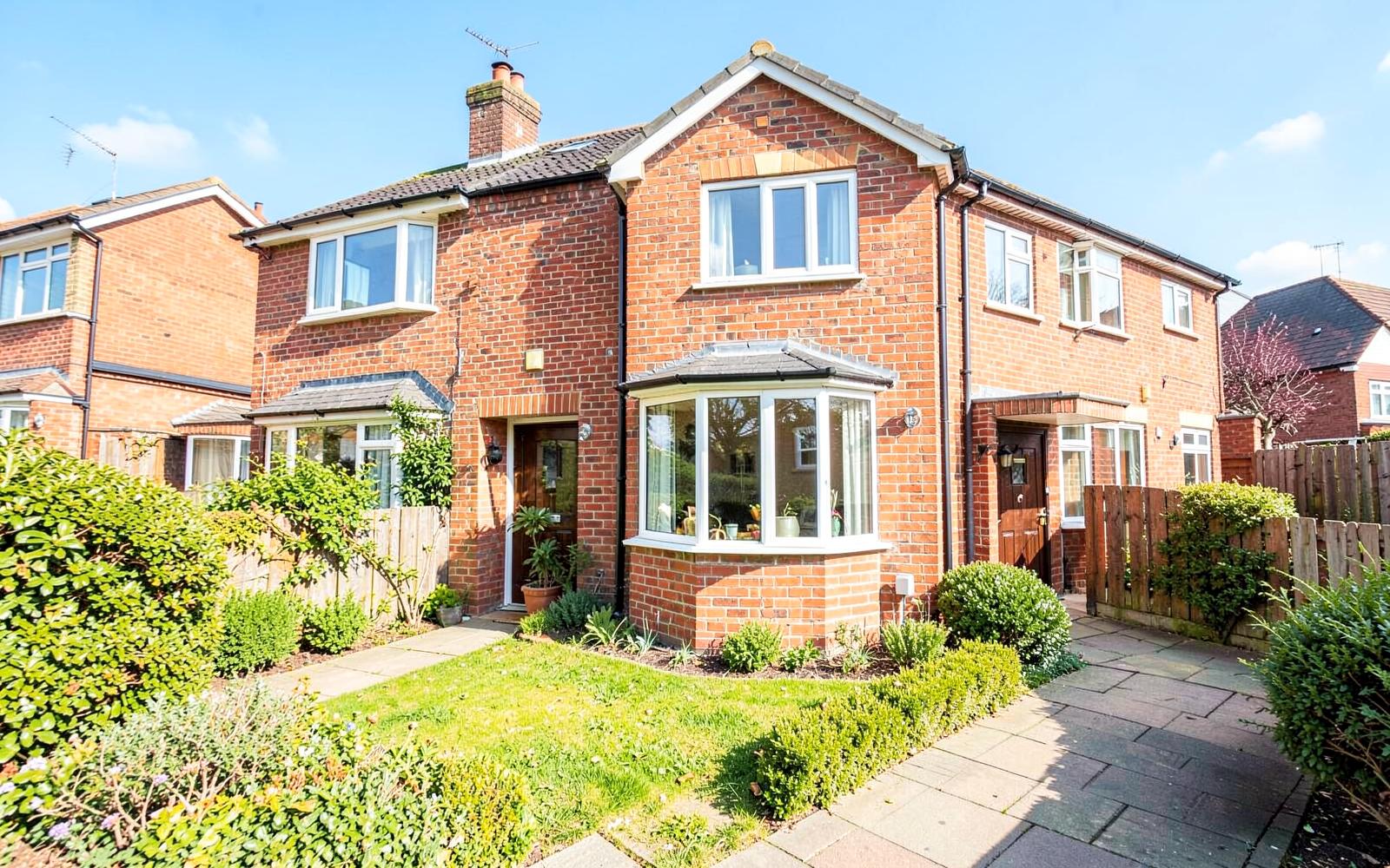 Red brick British semi-detached family home with bay windows